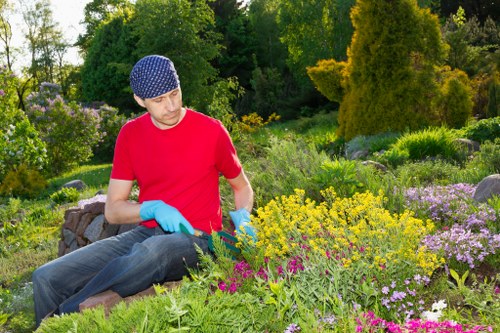 Team coordinating garden maintenance with safety equipment